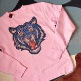 pink pullover | blue tiger